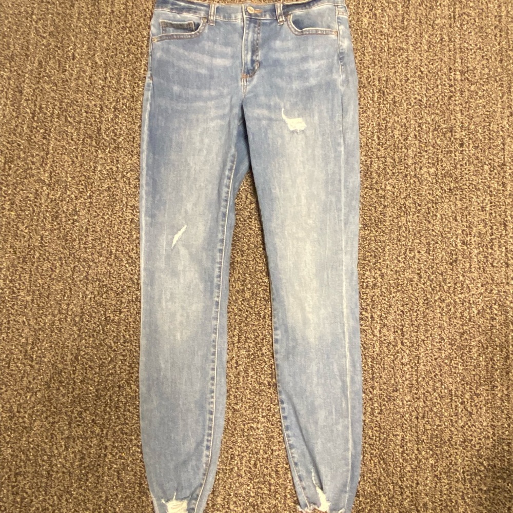 Blue skinny stretchy jeans with rips and distressed bottoms